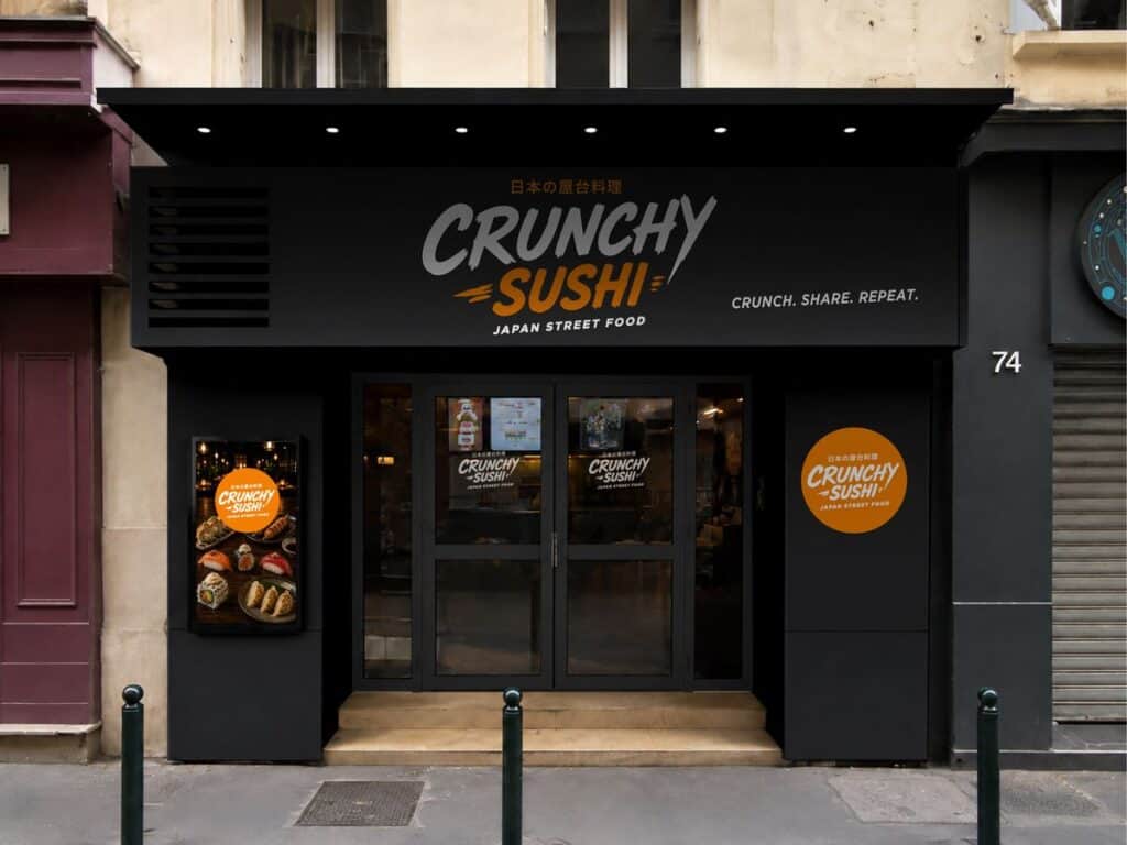 Façade du restaurant Crunchy Sushi avec logo et affiches de plats japonais.